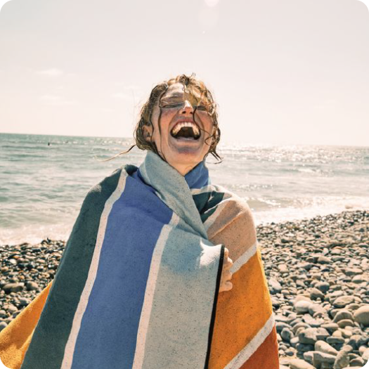 rocky beach towel girl laughing